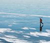 Person walks across frozen Lake Mendota