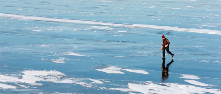Person walks across frozen Lake Mendota