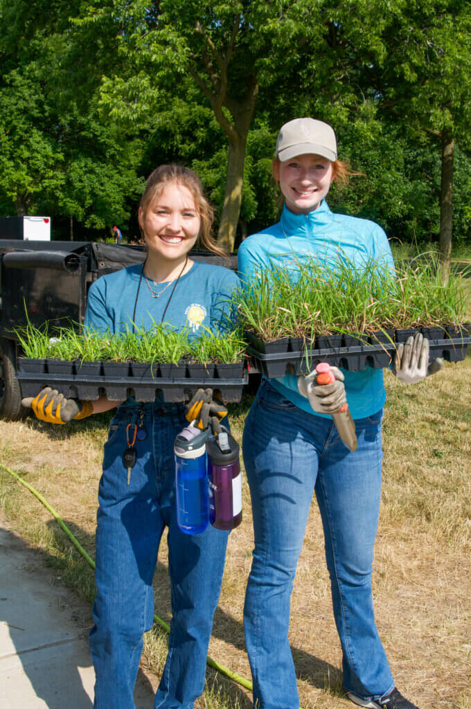 Volunteers from CG Schmidt plant native plants at Warner Park, June 2023